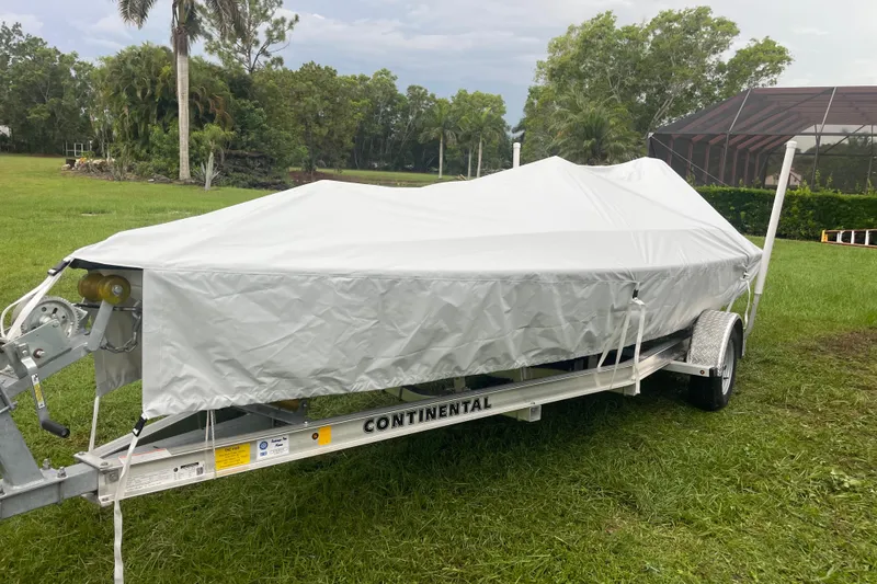 Slide: The Image of Covered boat on trailer in grassy area, JJM VS 1985 model. - 10