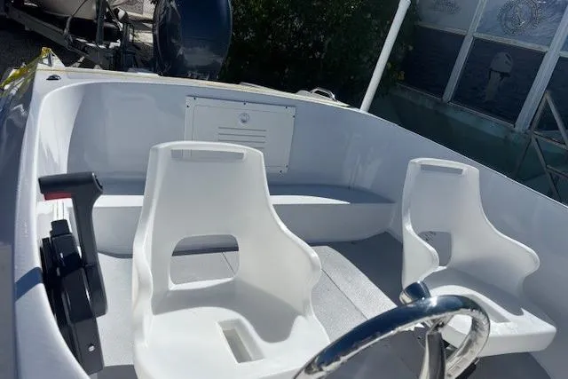 Slide: The Image of 1985 JJM VS boat interior with white seats and steering wheel. - 7