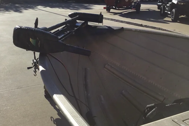 Slide: The Image of 2000 Tracker Guide V-14 Laker boat with motor, parked on a sunny day. - 4