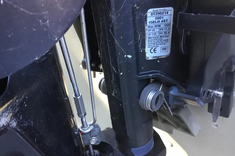 Slide: The Image of Close-up of a 2000 Tracker Guide V-14 Laker boat motor with visible serial number. - 7