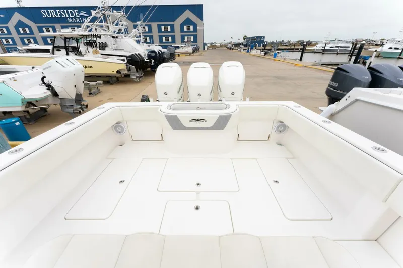 Slide: The Image of 2019 Invincible 39 Open Fisherman boat at Sureside Marina, featuring triple outboard engines. - 13