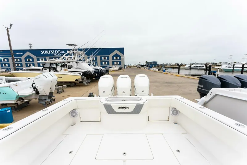 Slide: The Image of 2019 Invincible 39 Open Fisherman boat at marina, featuring triple outboard engines. - 14