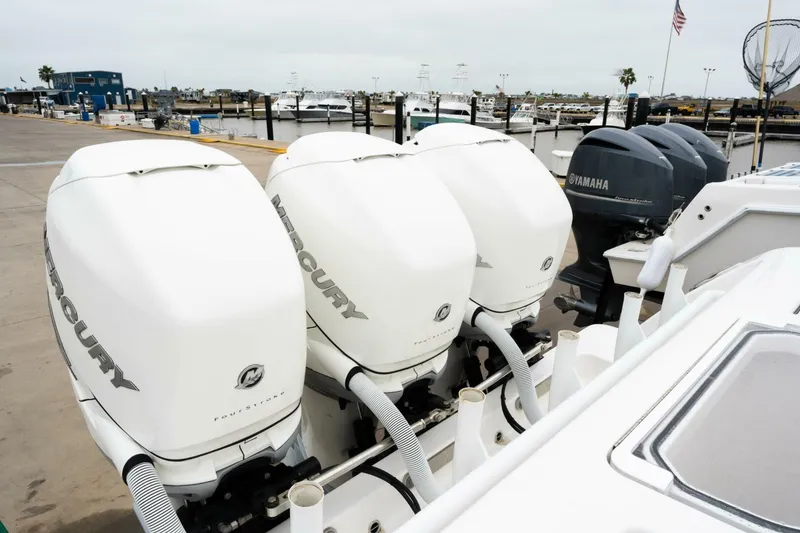 Slide: The Image of Four powerful outboard engines on a 2019 Invincible 39 Open Fisherman boat at a marina. - 15