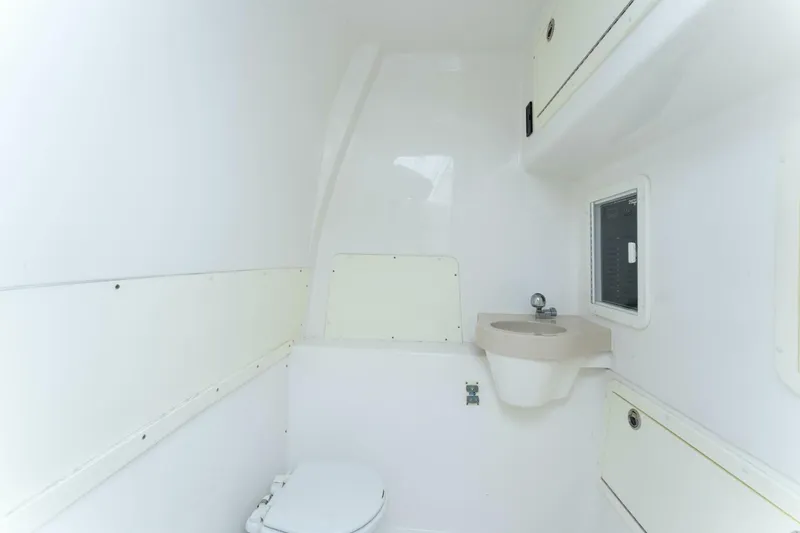 Slide: The Image of 2019 Invincible 39 Open Fisherman boat bathroom with toilet and sink. - 16