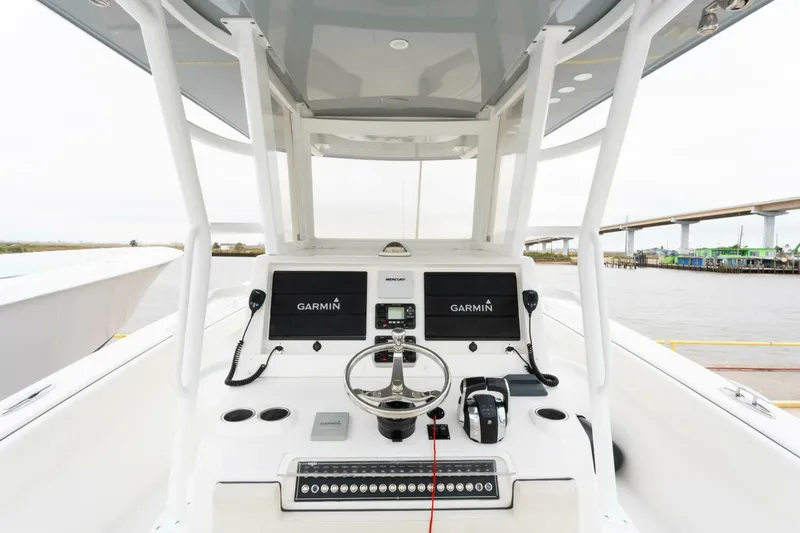 Slide: The Image of 2019 Invincible 39 Open Fisherman boat console with Garmin displays and steering wheel. - 2
