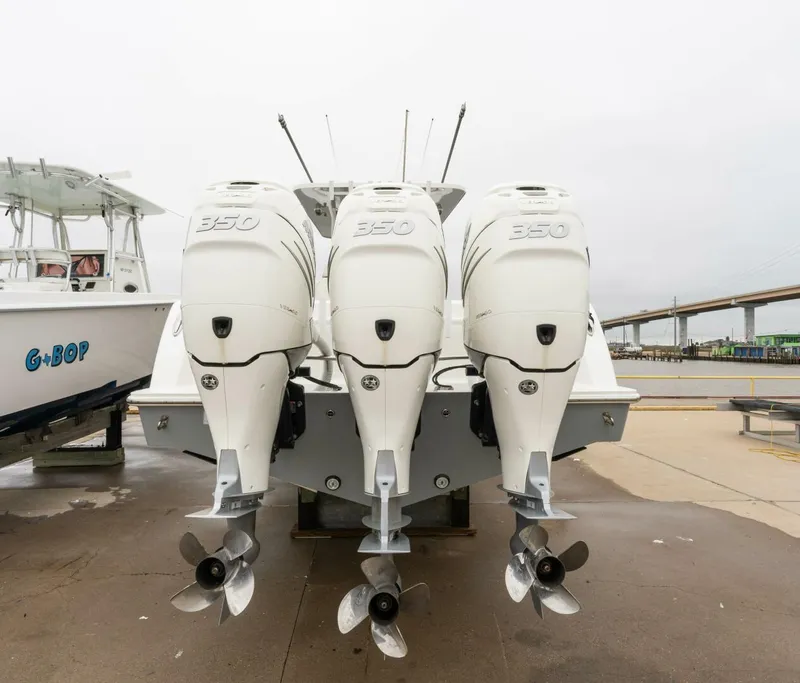 Slide: The Image of 2019 Invincible 39 Open Fisherman with triple 350 engines, docked on a cloudy day. - 21