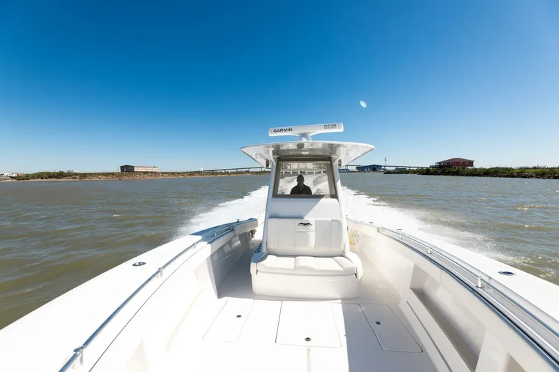 Slide: The Image of 2019 Invincible 39 Open Fisherman boat cruising on open water under clear blue sky. - 22