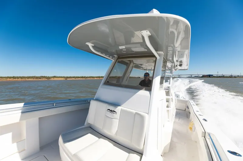 Slide: The Image of 2019 Invincible 39 Open Fisherman boat cruising on open water under clear blue sky. - 24