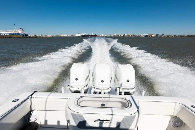 Slide: The Image of 2019 Invincible 39 Open Fisherman boat with triple engines cruising on open water. - 30