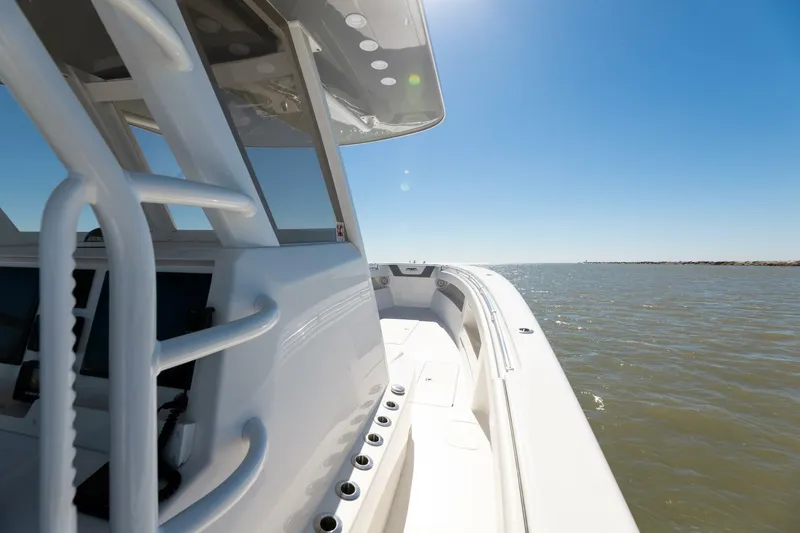 Slide: The Image of 2019 Invincible 39 Open Fisherman boat cruising on open water under clear blue sky. - 33