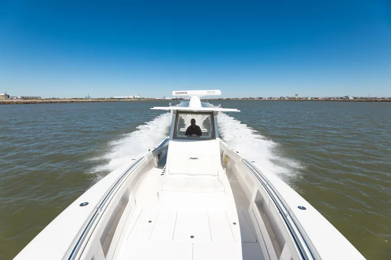 Slide: The Image of 2019 Invincible 39 Open Fisherman speeding on open water under clear blue sky. - 35
