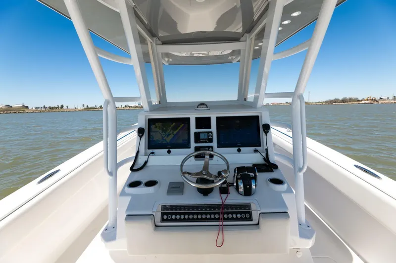 Slide: The Image of 2019 Invincible 39 Open Fisherman boat console with dual screens and steering wheel. - 36