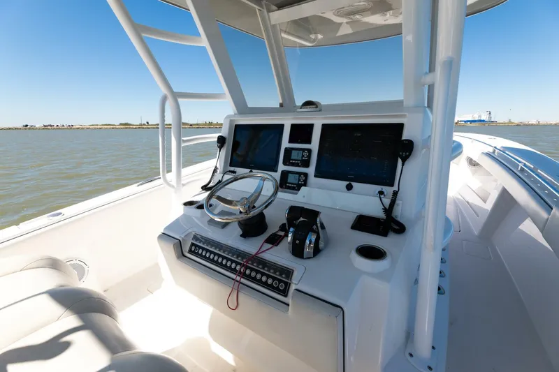 Slide: The Image of 2019 Invincible 39 Open Fisherman boat console with dual screens and steering wheel. - 37