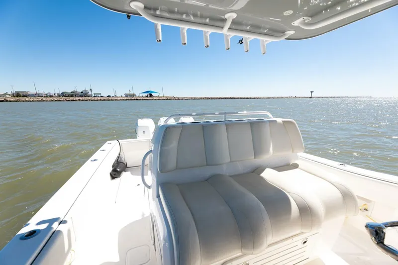 Slide: The Image of 2019 Invincible 39 Open Fisherman boat interior with seating, ocean view, and rod holders. - 38