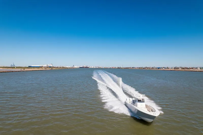 Slide: The Image of 2019 Invincible 39 Open Fisherman speeding on open water under clear blue sky. - 42