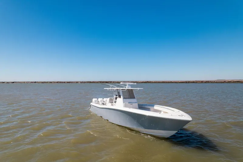 Slide: The Image of 2019 Invincible 39 Open Fisherman boat on calm waters under clear blue sky. - 45