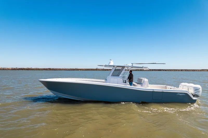 Slide: The Image of 2019 Invincible 39 Open Fisherman boat on calm water under clear blue sky. - 46