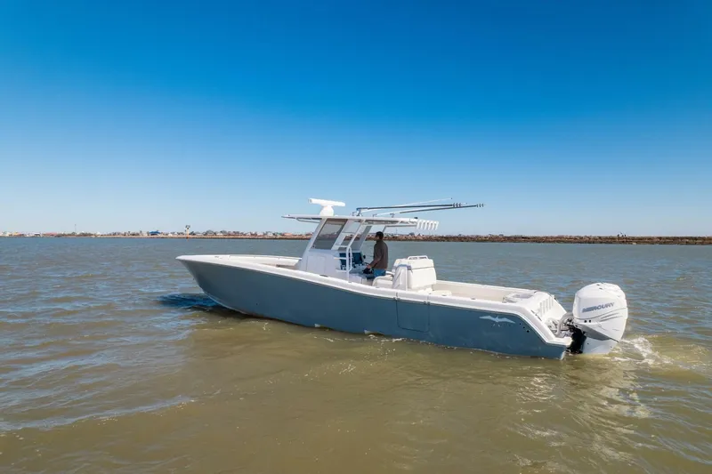Slide: The Image of 2019 Invincible 39 Open Fisherman boat cruising on calm waters under clear blue sky. - 47