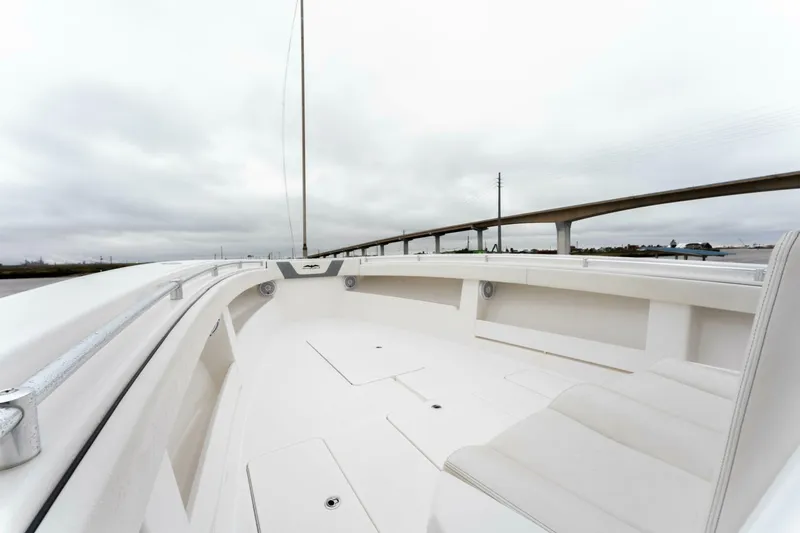 Slide: The Image of 2019 Invincible 39 Open Fisherman boat, spacious deck, overcast sky, bridge in background. - 5
