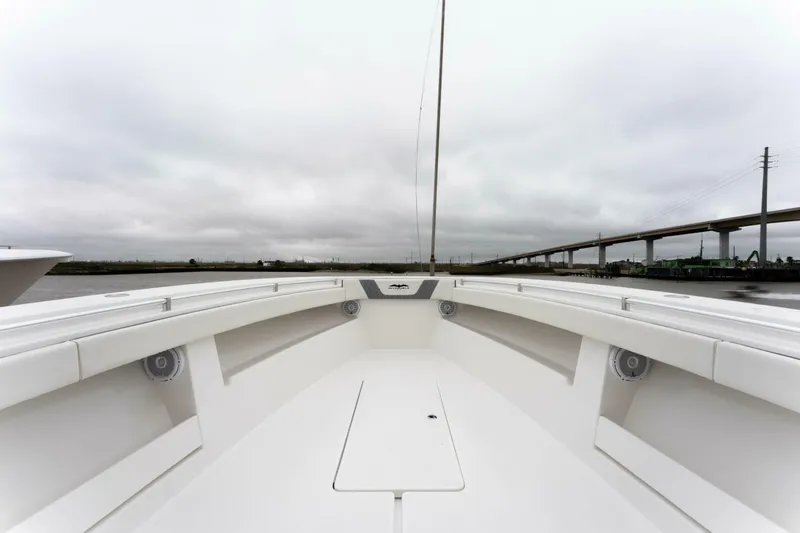 Slide: The Image of 2019 Invincible 39 Open Fisherman boat deck with overcast sky and bridge in background. - 6