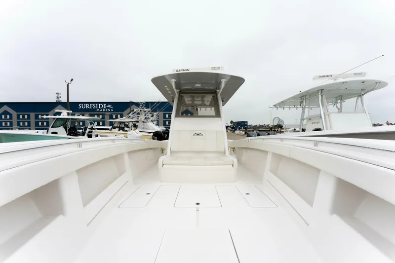 Slide: The Image of 2019 Invincible 39 Open Fisherman boat at marina, showcasing spacious deck and modern design. - 7