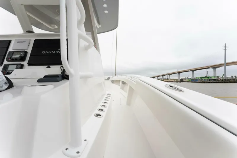 Slide: The Image of 2019 Invincible 39 Open Fisherman boat deck with modern controls and sleek design. - 9