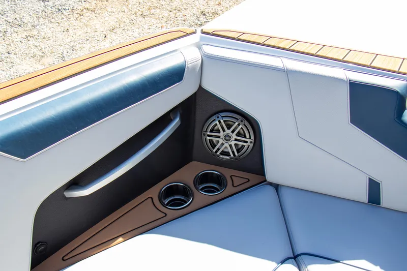 Slide: The Image of Interior of 2026 Nautique Super Air Nautique GS24, featuring speaker and cup holders. - 13