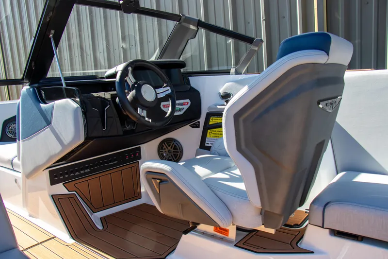 Slide: The Image of 2026 Nautique Super Air Nautique GS24 boat interior with modern helm and seating. - 14
