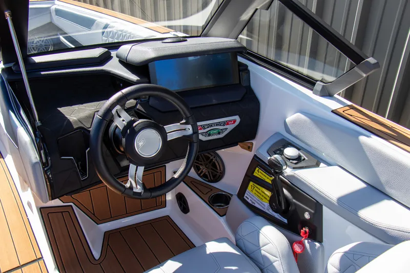 Slide: The Image of 2026 Nautique Super Air Nautique GS24 cockpit with modern steering and control panel. - 15