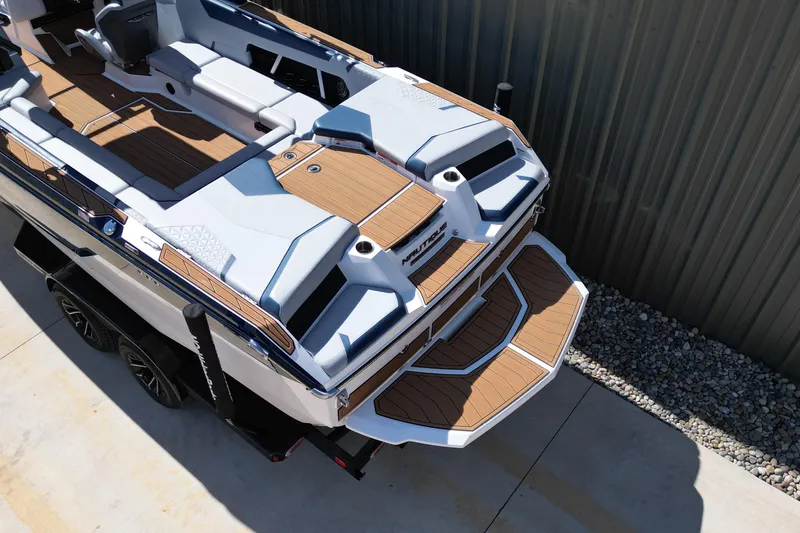Slide: The Image of 2026 Nautique Super Air Nautique GS24 boat with sleek design and spacious deck. - 23