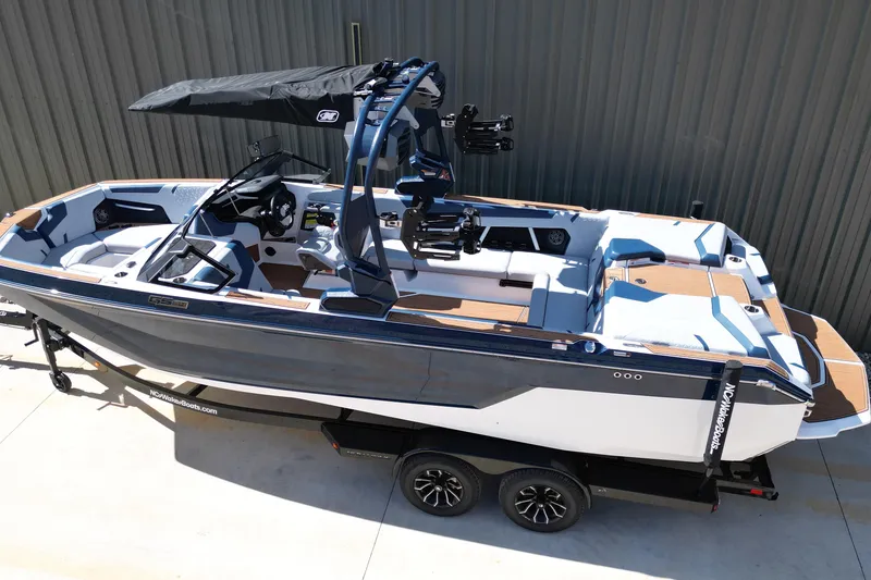 Slide: The Image of 2026 Nautique Super Air Nautique GS24 boat on trailer, featuring sleek design and modern amenities. - 24