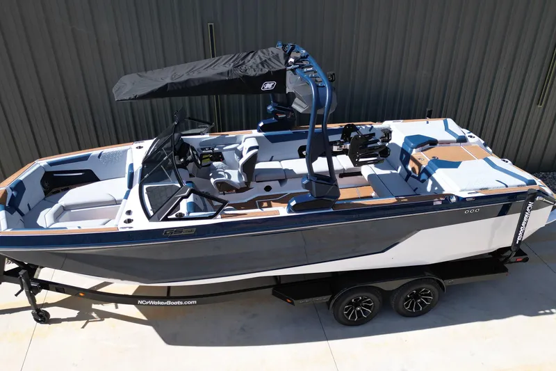 Slide: The Image of 2026 Nautique Super Air Nautique GS24 boat on trailer, side view. - 25