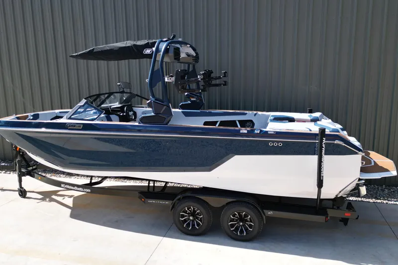 Slide: The Image of 2026 Nautique Super Air Nautique GS24 boat on trailer, side view. - 29