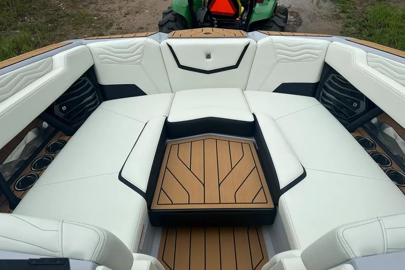 Slide: The Image of 2025 Nautique Super Air Nautique G23 boat interior with white seating and wood accents. - 10