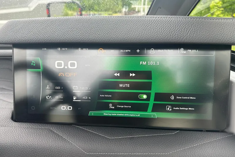 Slide: The Image of 2025 Nautique Super Air Nautique G23 dashboard display showing audio and system controls. - 11