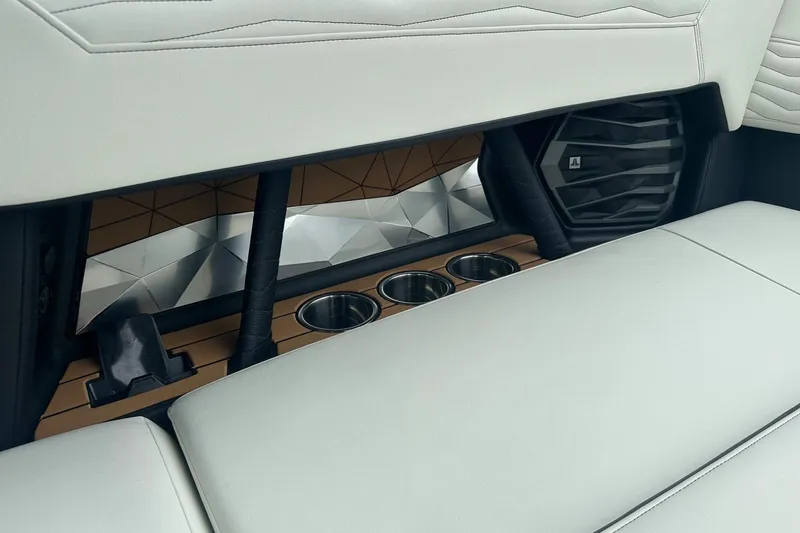 Slide: The Image of 2025 Nautique Super Air Nautique G23 interior with cup holders and speaker detail. - 12