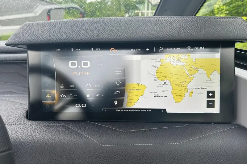 Slide: The Image of 2025 Nautique Super Air Nautique G23 dashboard display with navigation and control settings. - 14