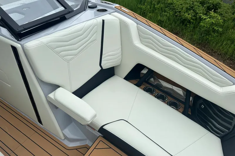Slide: The Image of Luxurious seating on 2025 Nautique Super Air Nautique G23 boat, featuring sleek white upholstery. - 18