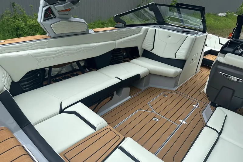 Slide: The Image of 2025 Nautique Super Air Nautique G23 interior with luxurious seating and teak flooring. - 20