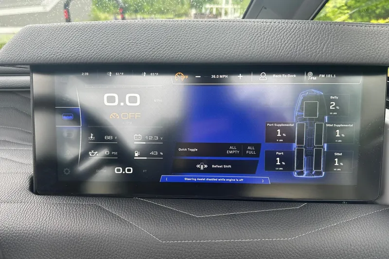 Slide: The Image of 2025 Nautique Super Air Nautique G23 dashboard display showing speed, ballast, and system status. - 21