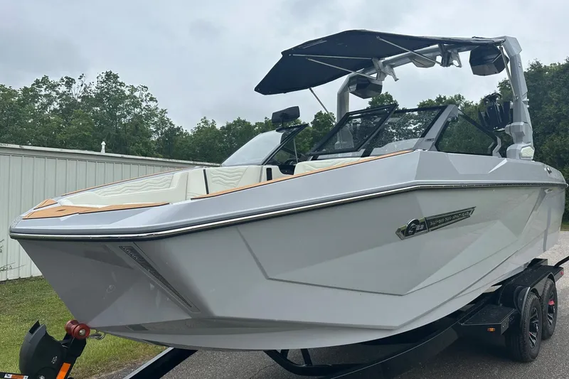 Slide: The Image of 2025 Nautique Super Air Nautique G23 boat on trailer, sleek design, overcast sky. - 3