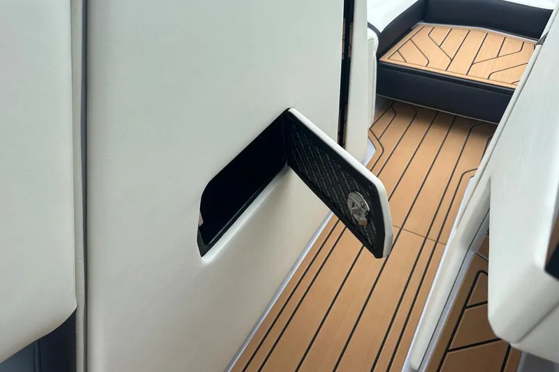 Slide: The Image of 2025 Nautique Super Air Nautique G23 interior with sleek storage compartment and teak-style flooring. - 31