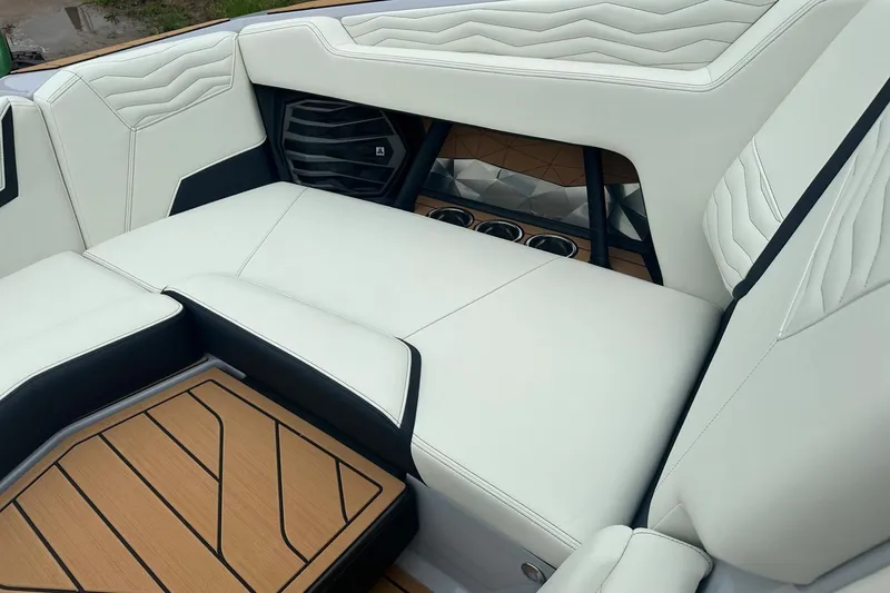 Slide: The Image of 2025 Nautique Super Air Nautique G23 interior with white leather seating and wood accents. - 32