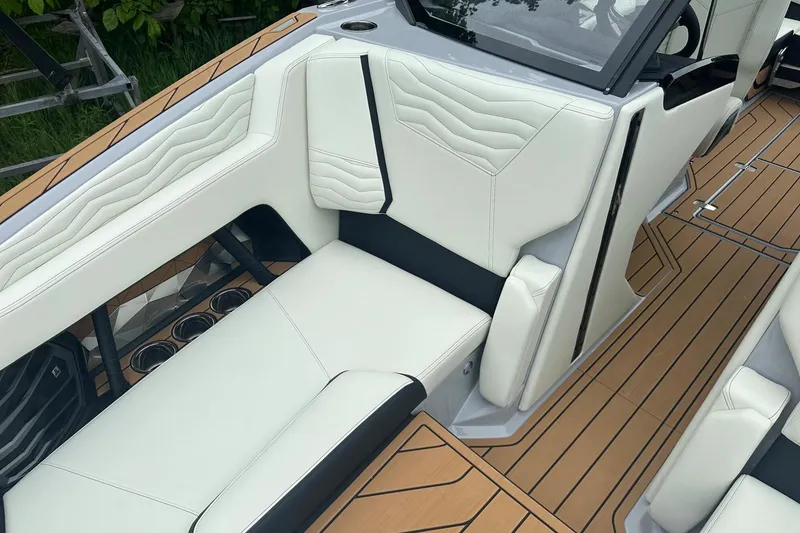 Slide: The Image of 2025 Nautique Super Air Nautique G23 interior with white upholstery and teak flooring. - 33