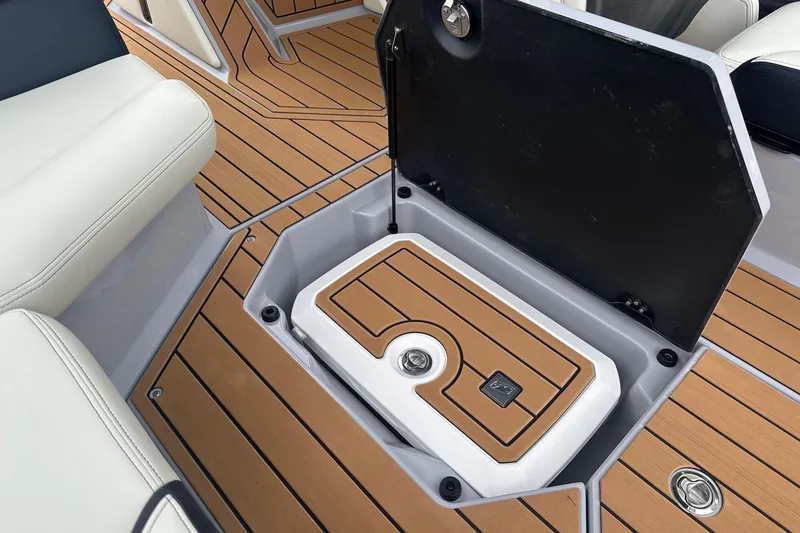 Slide: The Image of 2025 Nautique Super Air Nautique G23 storage compartment with teak flooring. - 37