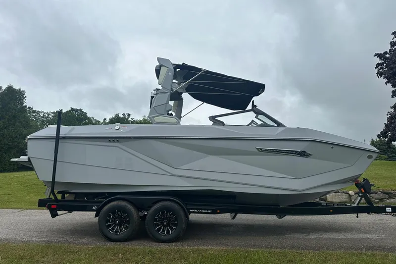 Slide: The Image of 2025 Nautique Super Air Nautique G23 boat on trailer, side view, overcast sky. - 4