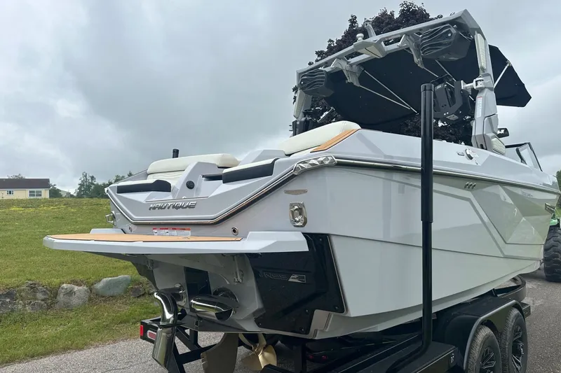 Slide: The Image of 2025 Nautique Super Air Nautique G23 boat on trailer, rear view. - 6