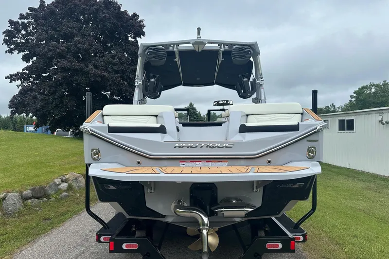 Slide: The Image of 2025 Nautique Super Air Nautique G23 boat, rear view, parked on a trailer. - 7