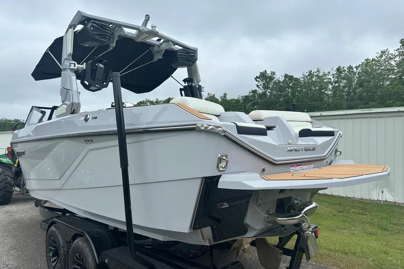 Slide: The Image of 2025 Nautique Super Air Nautique G23 boat on trailer, rear view, overcast sky. - 8