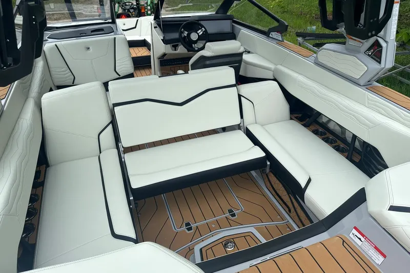 Slide: The Image of 2025 Nautique Super Air Nautique G23 interior with luxurious white seating and modern design. - 9